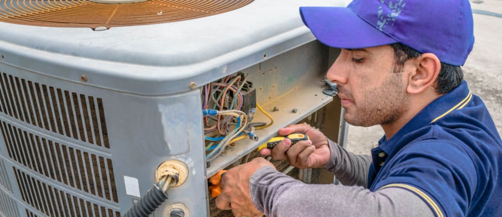 Electrician Working On Air Conditioner